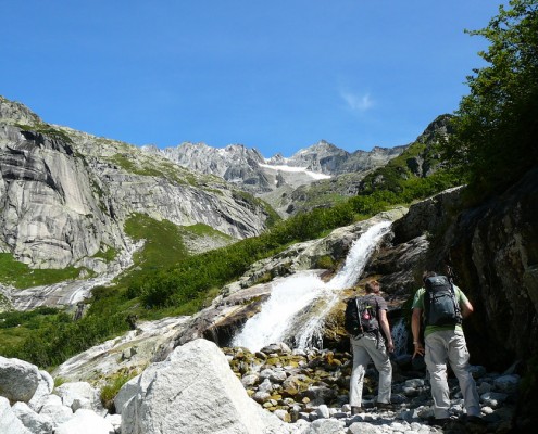 Waterfall and mountain massif surrounding Lake Gelmer.