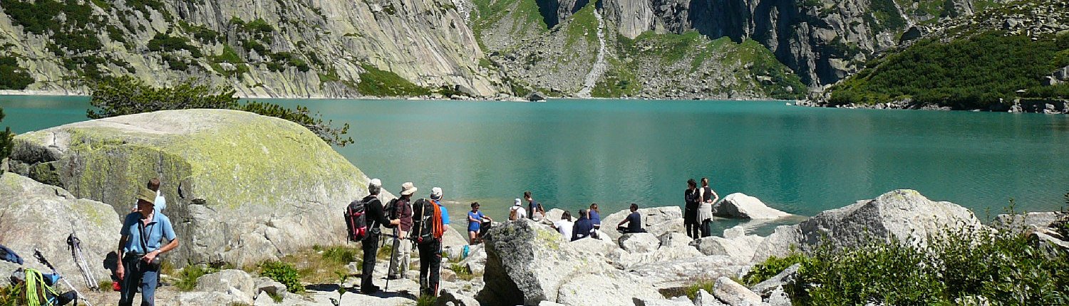 Tourists at the lake Gelmer, Hasli valley.
