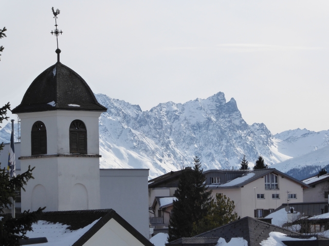 A view from Lenzerheide Vaz/Obervaz in Switzerland in winter. The bell tower of San Carlo church in Lenzerheide.